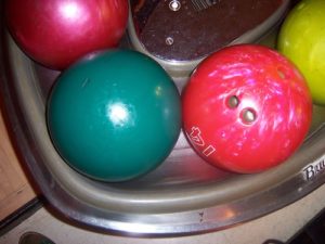 bright bowling balls at bowling alley lane
